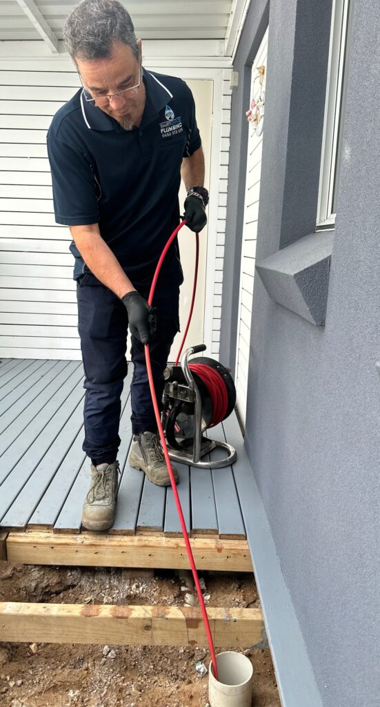 Smart Choice Plumbing clearing a blocked drain