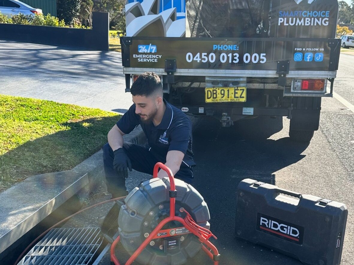 Smart Choice Plumbing plumber setting up a high-pressure water jetter at a stormwater pit in Campbelltown